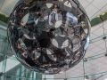 A black glass sphere chandelier dominates the lobby.