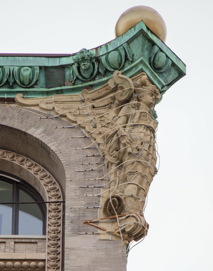 Two terra cotta angels support the cornice on the Nassau Street facade - helped by lots of iron straps.