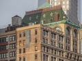 A three-story hipped roof caps the building's tower; it is only visible from a high or distant viewpoint.