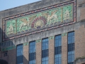 See City Review articlee for frieze details. Note the flared green and bronze panels, simulating tops of columns (between topmost windows).