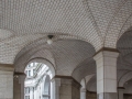 Under the south wing, a vaulted arcade shelters an entrance to the subway.