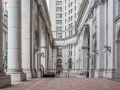 A four-story-high colonnade screens a courtyard along the front (NW) facade.