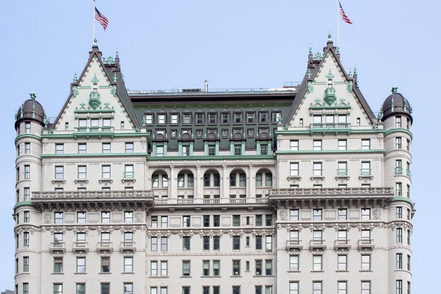 A fantastic mansard roof crowns Plaza Hotel, underscored by tiers of balustrades and terra cotta.
