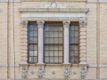 A second-story window with columns and pilasters