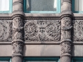 Wider spandrels on Fifth Avenue facade.